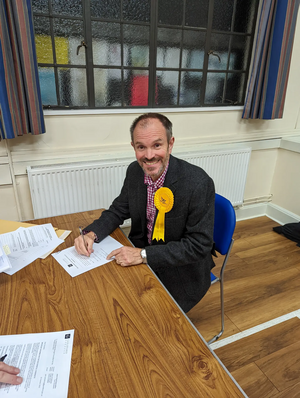 Newly elected councillor Richard Morris signing his declaration of acceptance of office