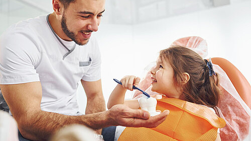 Dentist treating a young girl